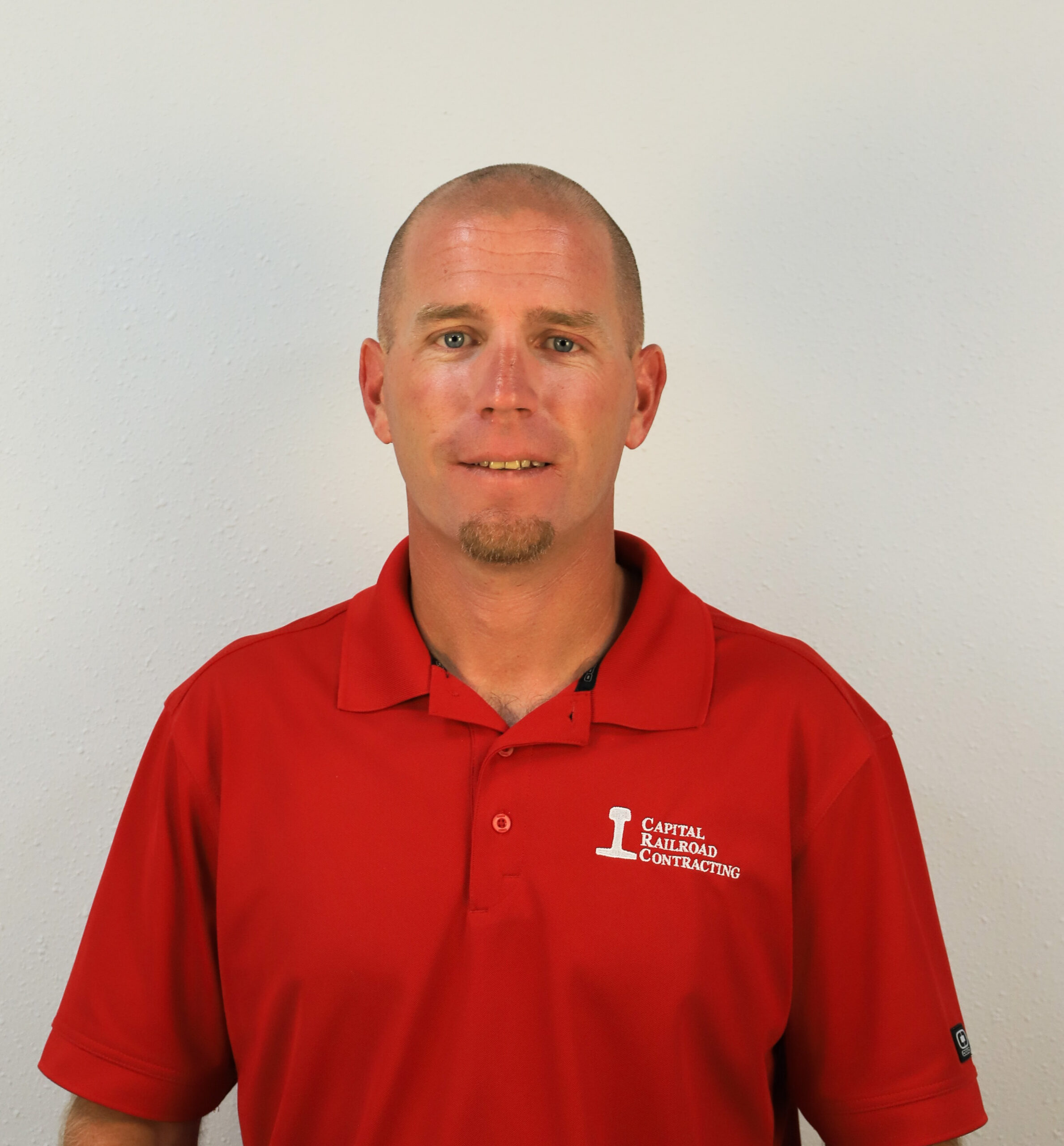 Man in red shirt standing still.