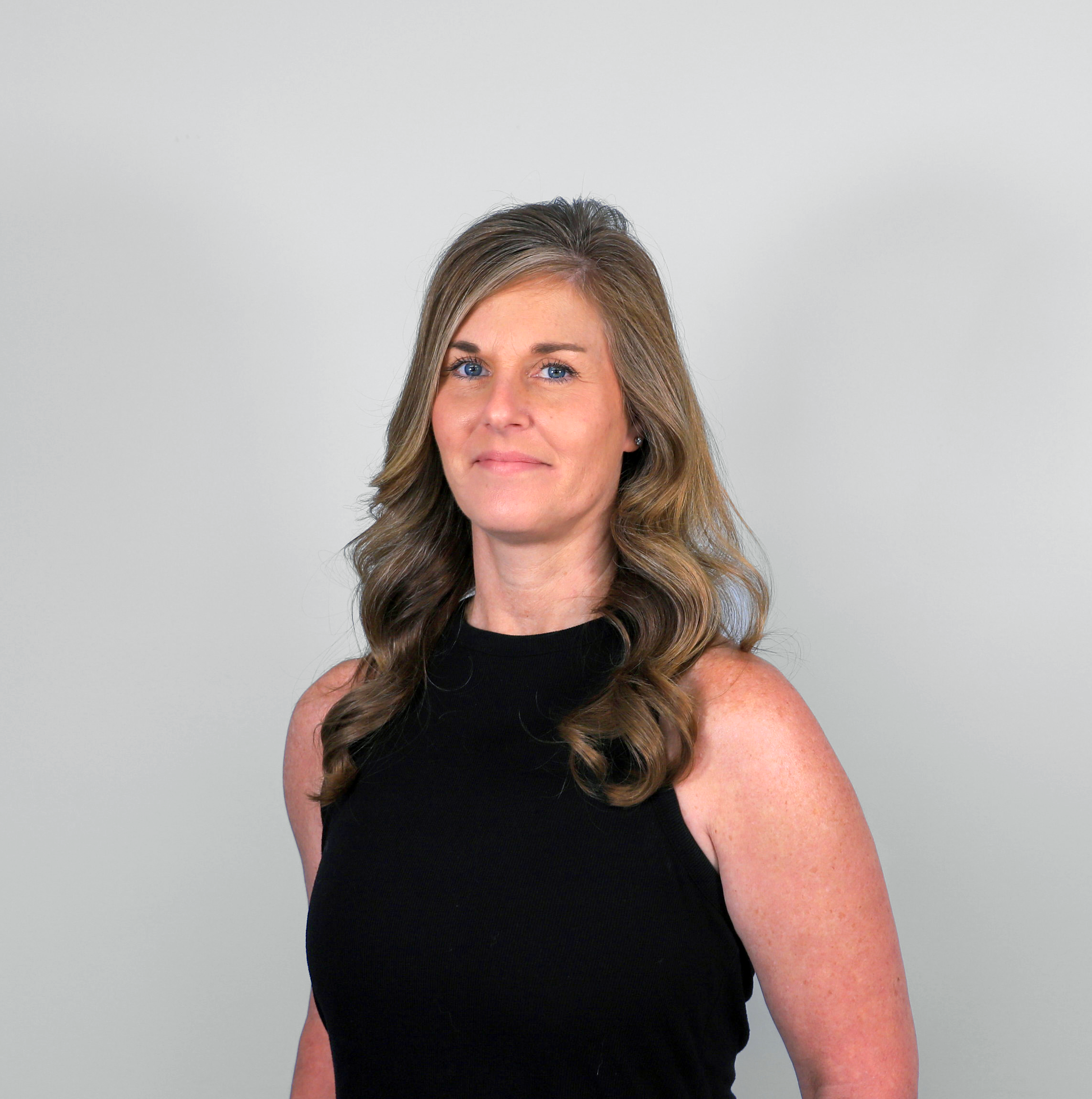 Woman with wavy hair, black top