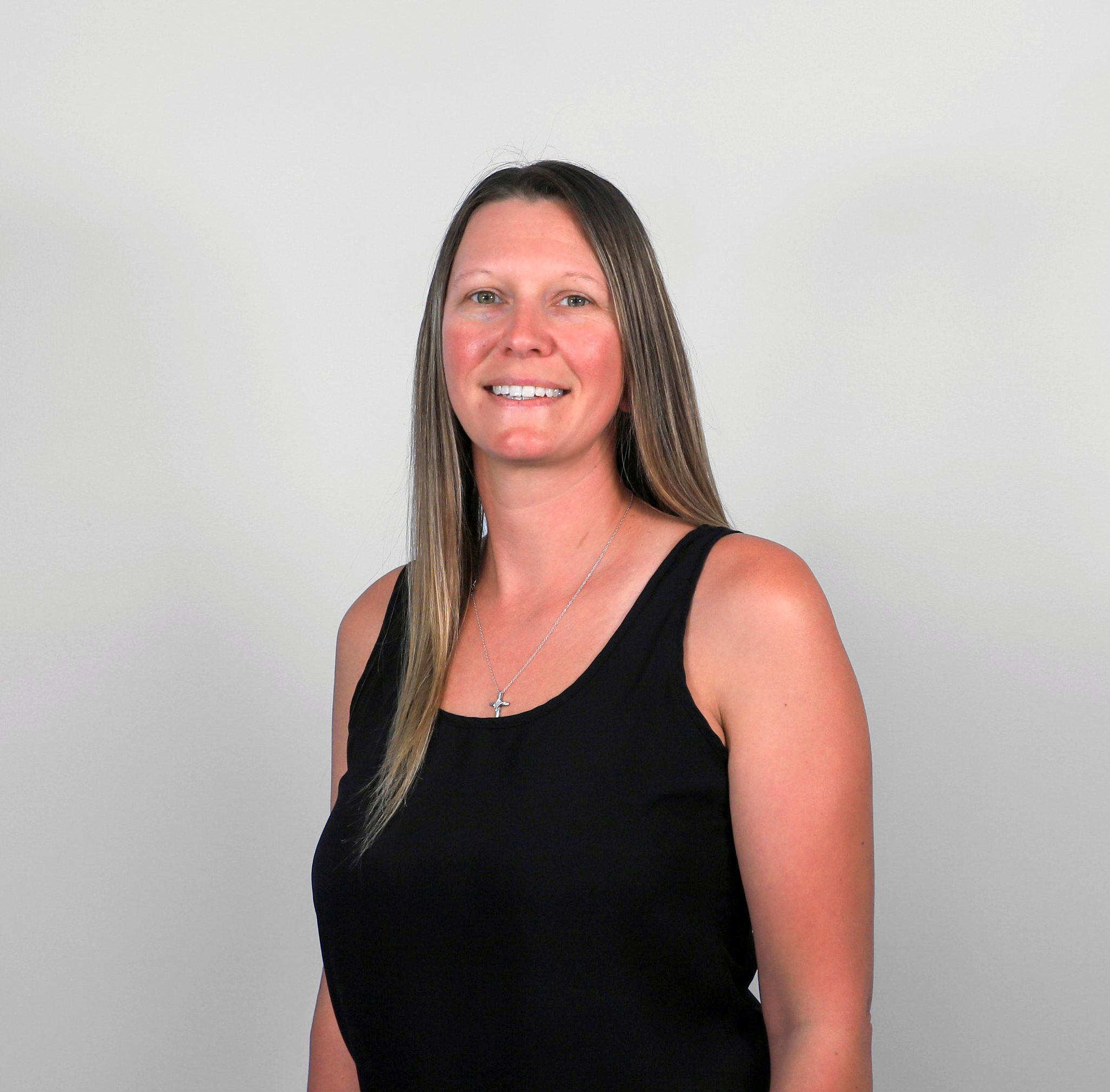 Woman in black tank top standing