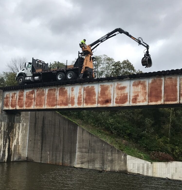 Truck on bridge with machinery operator