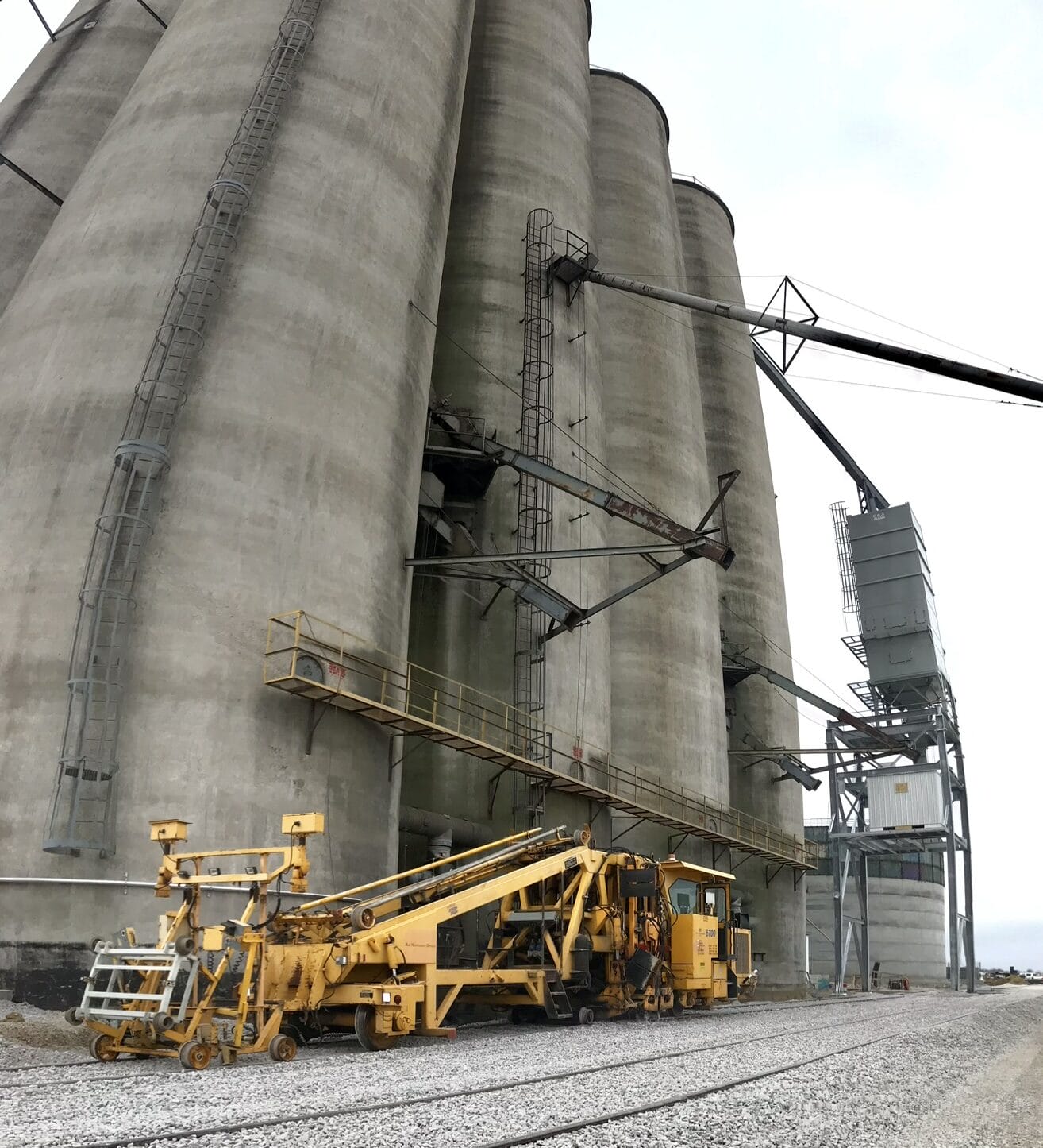 Industrial silos with machinery nearby