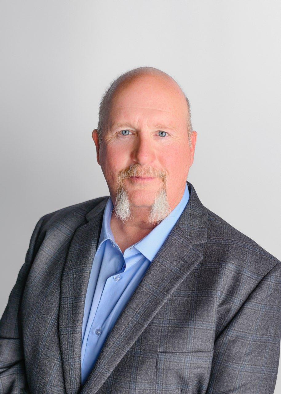 Man in gray blazer and blue shirt